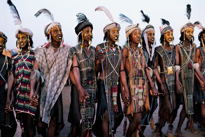 Young Wadabi men, Niger, 1986, NIGER-10013NF10 These young Wadabi men are taking part in the Garawal, an annual marriage ritual performed by the tribe. In this event, dramatic make-up is applied to the faces of the men, who dance and make exaggerated expressions in an attempt to attract new brides. The men dance for hours, and then the women come and choose the most handsome to be their husbands. Phaidon, Iconic Images, final book_iconic, iconic photographs